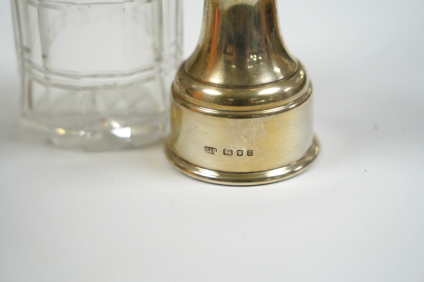 A modern silver mounted pepper mill, London, 1973, 86mm and a Victorian silver mounted glass vinegar bottle. Condition - poor to fair